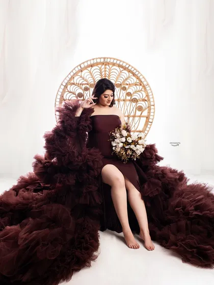 Combining two of my popular themes, this shot features a client in a dramatic ruffled gown seated in the boho peacock chair. The result is a unique, high-fashion maternity portrait.