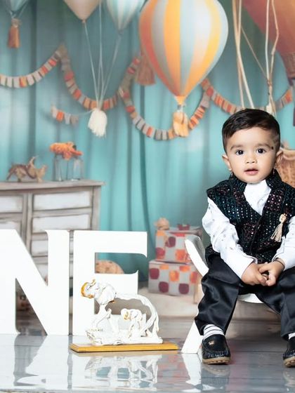 A more formal portrait from the travel-themed birthday shoot, with the little one looking straight at the camera.