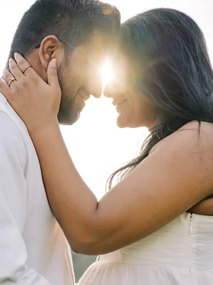 This is the magic of golden hour. The sun creates a beautiful flare as the couple connects, forehead to forehead. It's an intimate, powerful silhouette that focuses purely on their love.