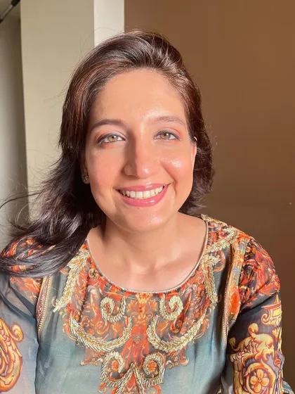 A sun-kissed shot of this dewy makeup look. The natural light highlights the glowing skin and the soft, shimmery eyeshadow.
