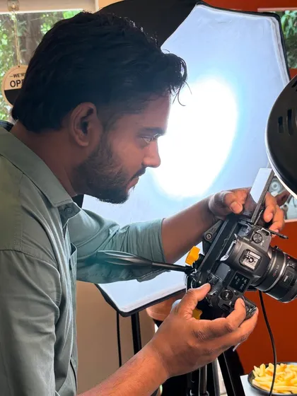 Focused on the details. Here I am setting up a shot for a food photography session, making sure the lighting is perfect to make the dish look as appetizing as possible.