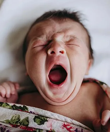 Another angle of a big newborn yawn. These candid moments are often the favorites from a newborn photography session.