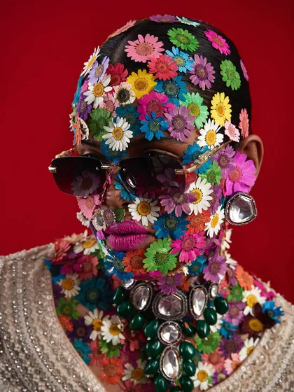 An extraordinary avant-garde concept where the model's face is covered in pressed flowers, creating a stunning and unique texture.