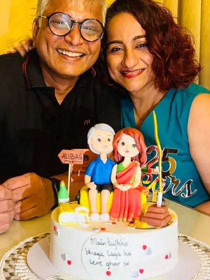 This cake tells the beautiful 25-year love story of a couple who eloped. We captured their journey with custom figurines and details representing their unique story, from their Catholic and South Indian backgrounds to where they first met.