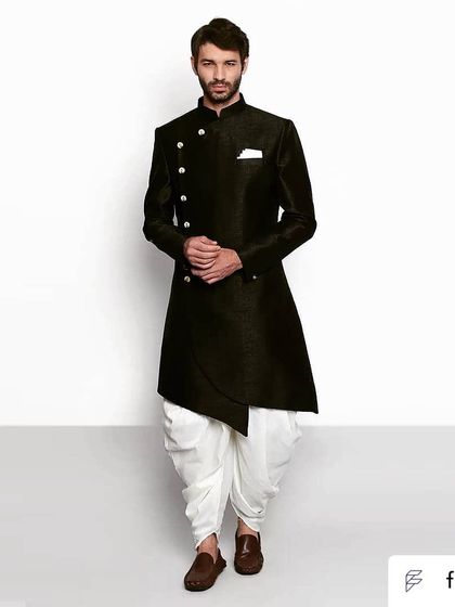 For those who like it a little quirky. This black asymmetric bandhgala paired with a white dhoti is a modern and stylish choice.