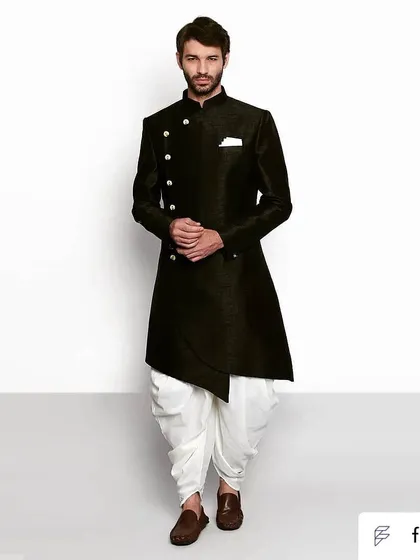 For those who like it a little quirky, this asymmetric black bandhgala paired with white dhoti pants offers a unique and fashionable silhouette.