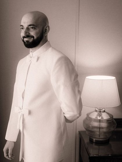 The groom, moments before the ceremony, with a gentle smile of anticipation. Capturing these individual moments of quiet reflection is key to telling the complete story of the day.