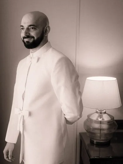 The groom, moments before the ceremony, with a gentle smile of anticipation. Capturing these individual moments of quiet reflection is key to telling the complete story of the day.