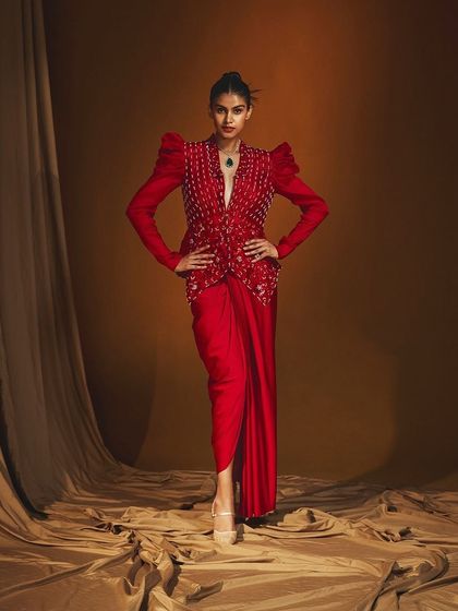 A full-length shot for Label Japji Arora's "Parisa" collection. The dramatic pose and flowing fabric were captured using specific lighting techniques to add a sense of movement and grandeur.
