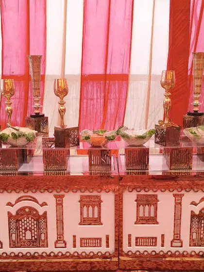 Our salad bar setup, featuring elegant decor and a traditional patterned counter. We use tall golden vases and provide a variety of fresh, crisp salads to start the meal on a healthy and beautiful note.