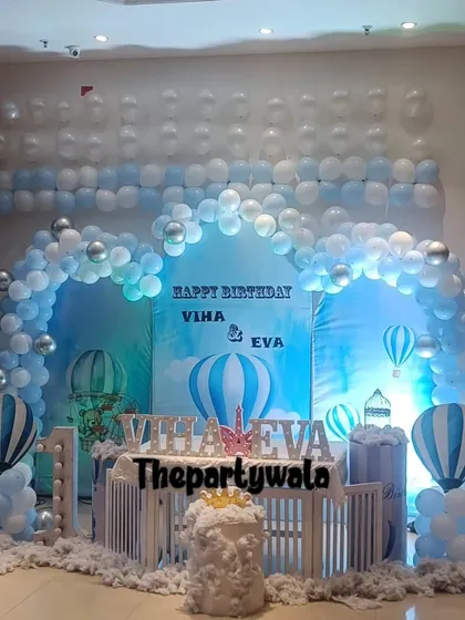 Up, up, and away! This Hot Air Balloon theme is perfect for a first birthday, with a beautiful blue sky backdrop, fluffy balloon clouds, and cute hot air balloon models. I can customize the colors for a baby boy or girl.