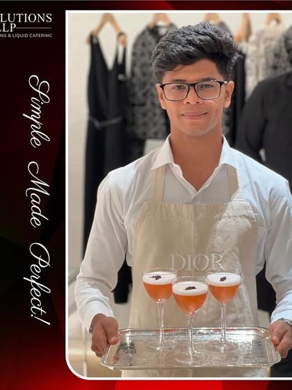 A server presenting a tray of our signature pink sours, garnished with edible flowers, at the DIOR client gathering.
