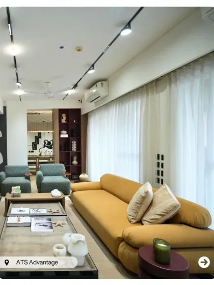 A bright and airy penthouse living room at ATS Advantage. The mustard yellow sofa adds a warm, inviting feel, while track lighting provides flexible and modern illumination.