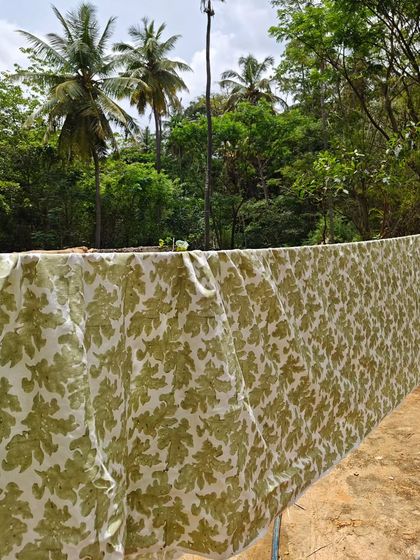 When the fabric matches the foliage. This light linen textile, printed with organic dyes, is seen drying in our garden, surrounded by the very nature that inspires our work.