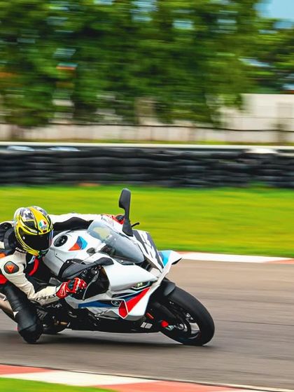 A rider going throttle wide open on the straight. The thrill of unleashing a superbike's power on a race track is an experience every enthusiast should have.