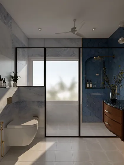 A full view of the bold blue bathroom, showing the spacious walk-in shower with a black-framed glass partition that contrasts beautifully with the blue and white marble tiles.