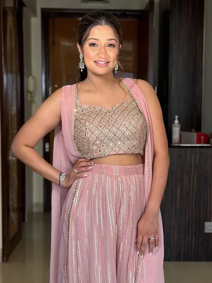 Another shot of this beautiful new mom. The soft pink tones in her makeup and outfit create a look that is gentle and celebratory.
