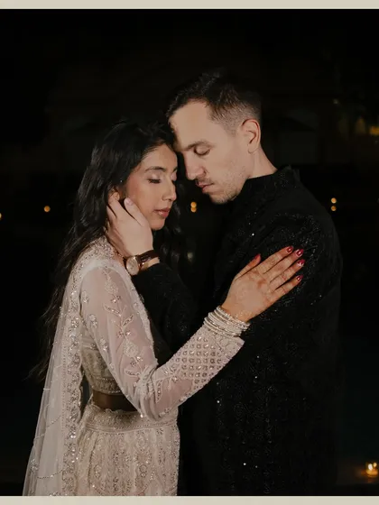 An intimate and tender moment between the couple during their evening celebration. This close-up portrait focuses on the emotional connection, capturing a quiet moment of love amidst the festivities.