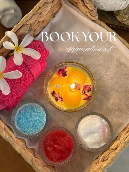 A close-up of the pedicure tray, complete with a lit candle, colorful scrubs, and fresh flowers. It's all about the little details.