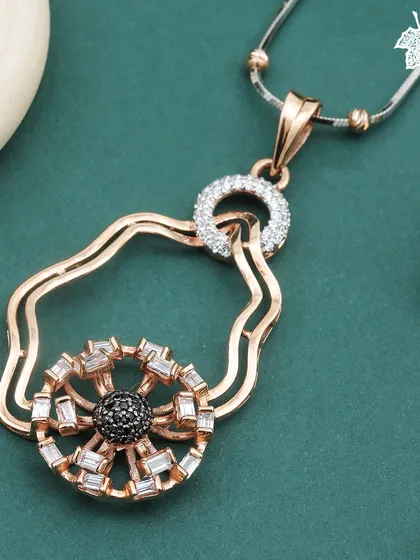 The Eclipse Glow pendant, an Art Deco inspired piece for the modern woman. A central cluster of black and white diamonds creates a dramatic focal point within an organic, free-form rose gold frame.