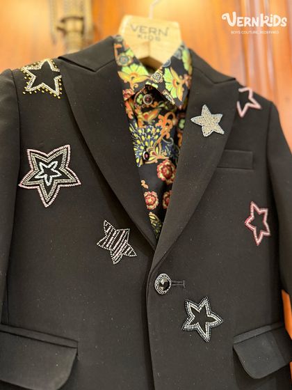 A close-up of the handcrafted star embellishments on our popular black blazer. Each star is carefully applied to create a unique, glamorous look.