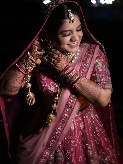A candid moment of laughter and joy as the bride gets ready.