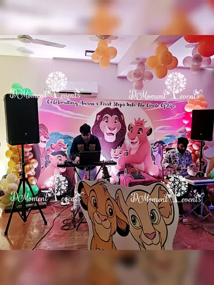The entertainment setup for the Lion King party, with a live band playing in front of a themed backdrop featuring Mufasa and Nala.