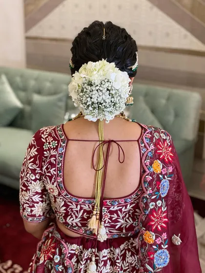 Another view of this classic all-white floral bun. It's a versatile look that works beautifully with any color of outfit, from deep reds to soft pastels.