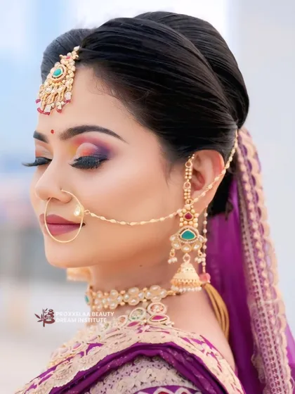 A close up of a classic bridal look, featuring a colorful smokey eye and a chic updo. This style is perfect for the modern bride who wants a touch of tradition with a whole lot of glam.