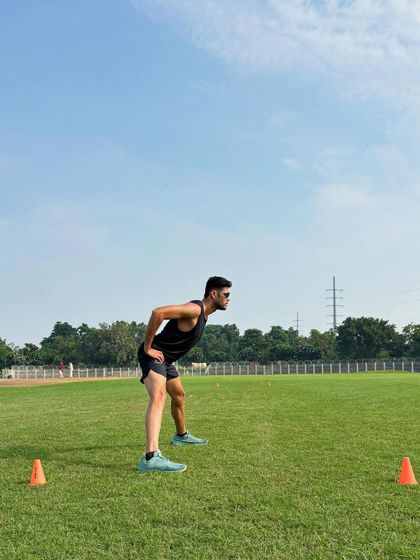 The ready position before a sprint. This athletic stance, with a forward lean and low center of gravity, is crucial for exploding off the mark and generating maximum force in the first few steps.