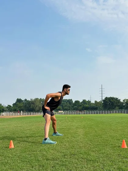 The ready position before a sprint. This athletic stance, with a forward lean and low center of gravity, is crucial for exploding off the mark and generating maximum force in the first few steps.