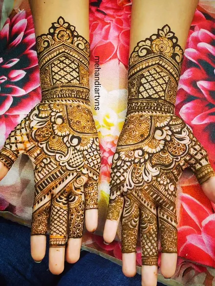 This design features heavy, intricate work on the palms with a mix of floral, paisley, and geometric elements, perfect for a grand celebration.