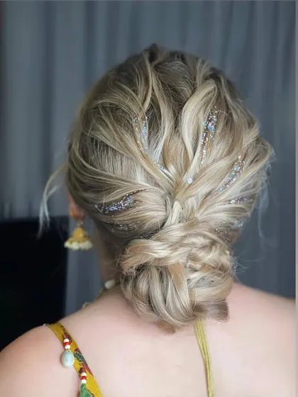 A close-up of the textured messy bun with glitter, showing how to add a touch of sparkle for an evening event.