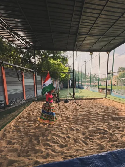 A young girl stands proudly with the Indian flag in our sandpit. This image beautifully captures the spirit of our community, a space that is open to all ages and celebrates the legacy of our nation.
