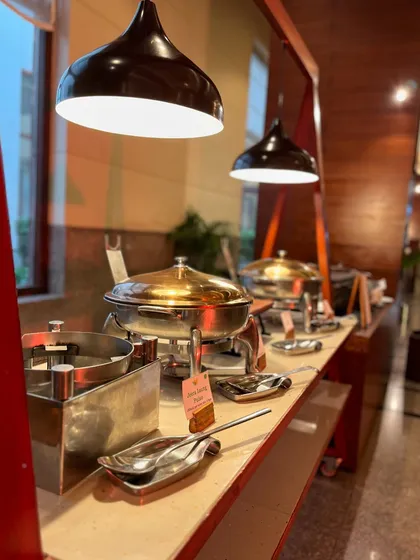 A modern and sleek buffet setup inside a hotel, showing our ability to adapt our catering style to any venue.