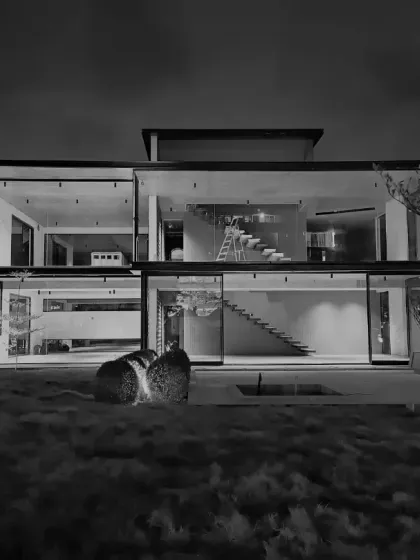 Integrating nature with transparency. This black and white night shot of a glass house shows how we weave stories through landscape and architecture.