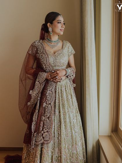A full-length view of this sparkling bridal lehenga. The makeup was kept elegant and refined to complement the heavily embellished outfit.