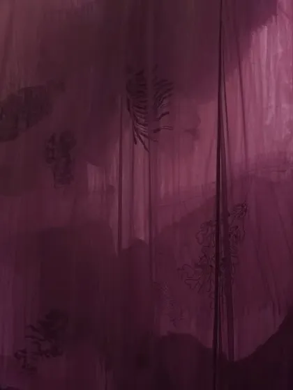 The 'Cardinal' installation, an exploration of deep emotion through color. Layers of translucent textile in shades of purple and magenta create a mysterious and introspective environment, with shifting opacities revealing a choreography of depth and light.