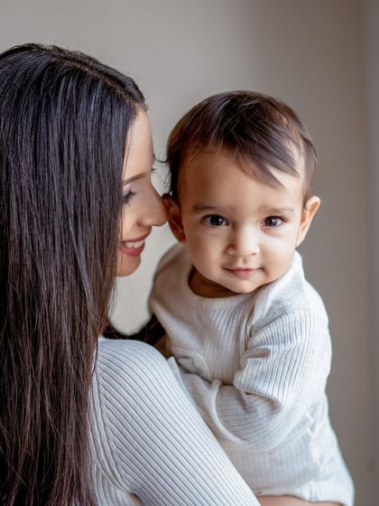 A sweet portrait of a mother and her baby. The baby's curious look at the camera is adorable.