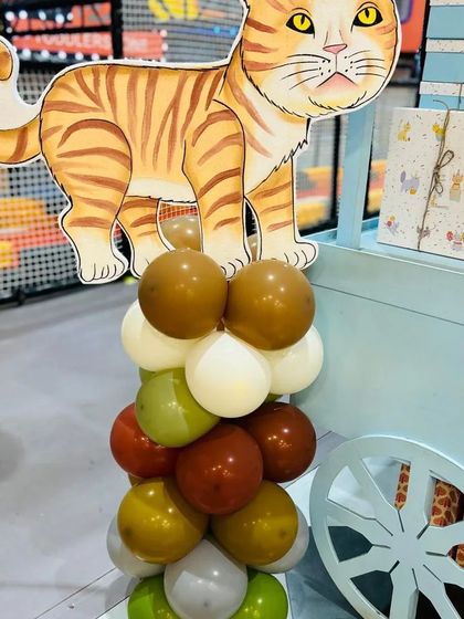 A cute cat cutout on a balloon column, one of the many small details that make our themed parties special.