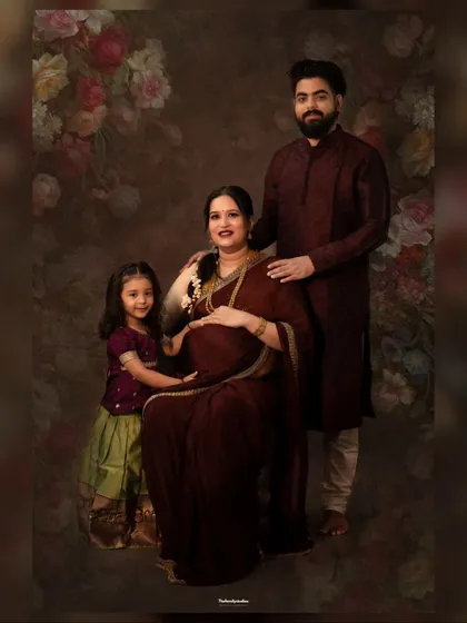 A fine art maternity portrait celebrating a growing family. We created this traditional, painterly look in our studio, complete with elegant attire and a classic backdrop to honor this special time before the new baby arrives.