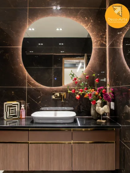 Even utilitarian spaces are an opportunity for elegance. In the Brandman office washroom, we blended dramatic back-lit mirrors with rich, dark marble to create a space of unexpected sophistication, proving our attention to detail in every corner.