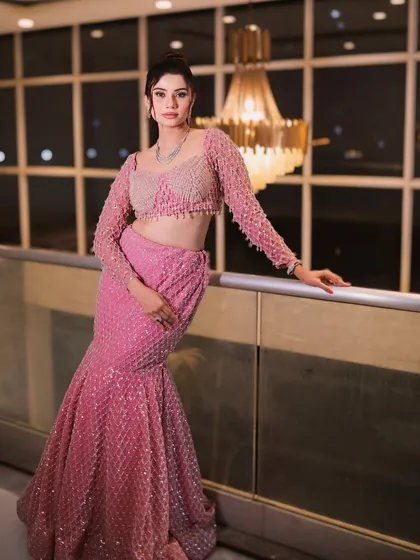 A full-length view of the pink sequined lehenga. The outfit is designed to catch the light and make a statement on the dance floor.