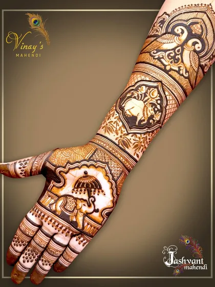 A single-hand view of the royal elephant design, showing the intricate details of the elephant's adornments and the peacock motifs on the arm.