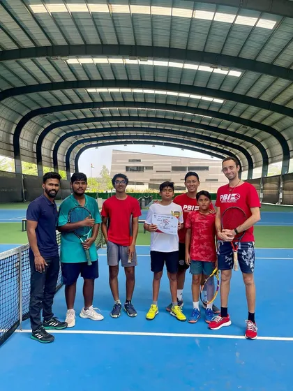 A group shot of a tournament winner with his support system of coaches and training partners. Peer support is a vital component of our training program.