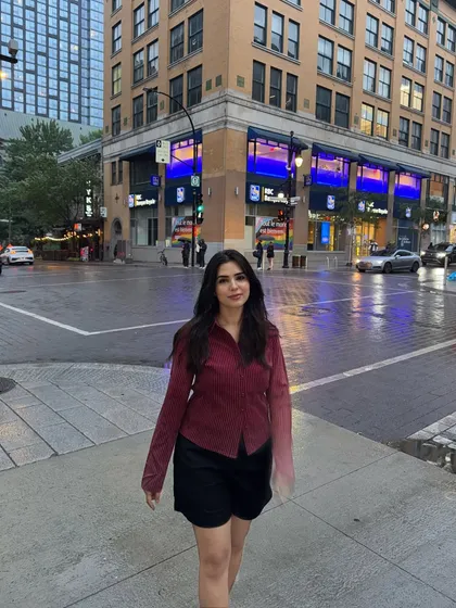 A full-body shot of my outfit against the backdrop of downtown Montréal's evening cityscape.