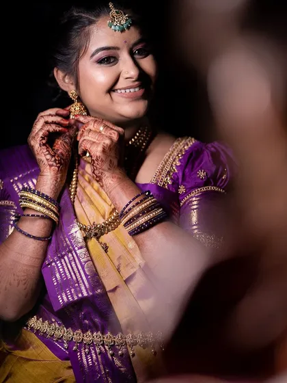 A candid of Varshini adjusting her earring, looking absolutely radiant.
