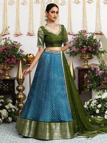 The full view of the teal blue and olive green lehenga, a unique and sophisticated color combination for the discerning woman.