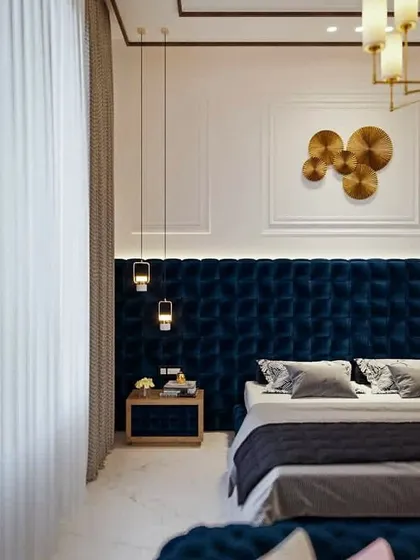 A luxury master bedroom concept designed by our team. It features a full-wall tufted velvet headboard, elegant pendant lights, and wall mouldings to create a rich and sophisticated ambiance.