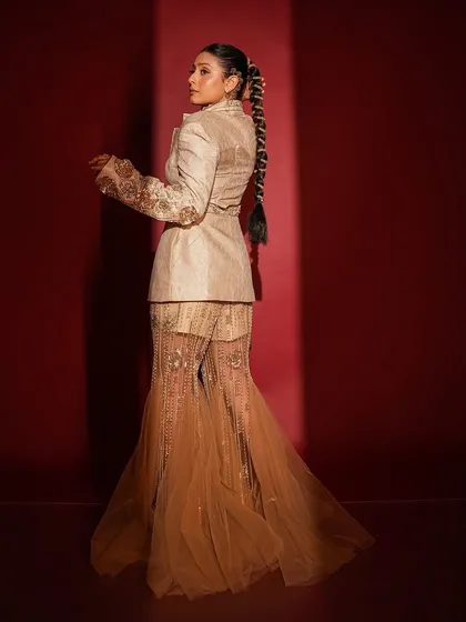 A full-length view of this unique Indo-western look for Isha Malviya. The makeup was kept elegant and defined to balance the intricate outfit and the statement braided hairstyle.